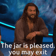 a man with a beard stands in front of a screen that says the jar is pleased you may exit