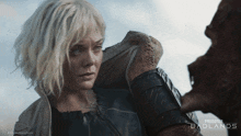 a poster for predator badlands shows a blonde woman