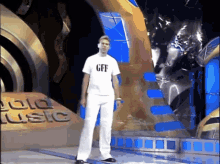 a man wearing a white shirt that says gff