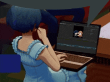a girl in a blue dress sits in front of a laptop
