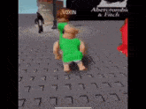 a person in a green shirt is walking on a brick floor in front of a sign for abercrombie & fitch .