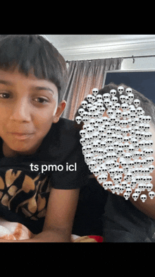 a young boy with skulls on his face and the words ts pmo icl