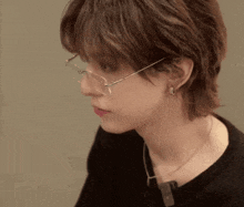 a close up of a woman wearing glasses and a black shirt