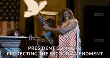 a man is holding a gun in front of an american flag while a dove is flying in the air .