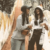 two women are walking down a set of stairs laughing