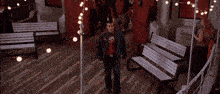 a group of people are standing in a room with a sign that says life jackets