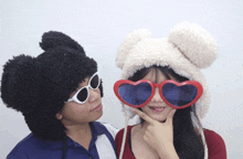 a man and a woman wearing sunglasses and hats
