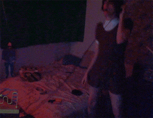 a person standing in a dark room with a doll on the bed