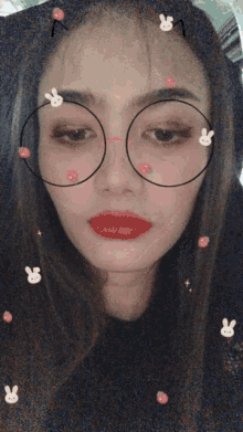 a woman wearing glasses with rabbits and flowers on her face