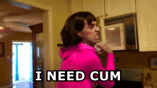 a woman in a pink hoodie says i need cum
