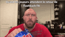 a man in a red shirt is holding a bag of mr. potato chips