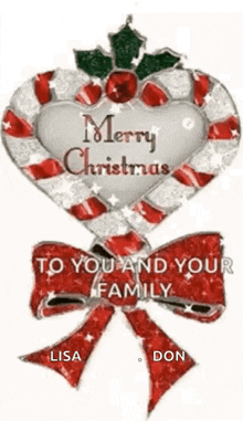 a candy cane in the shape of a heart with a bow and holly .