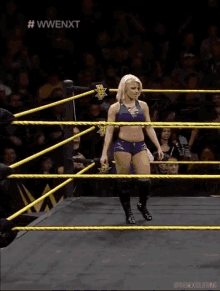 a woman in a wrestling ring with the words #wwenxt on the top