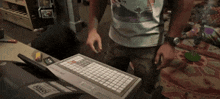 a man standing next to a keyboard that says oko on it