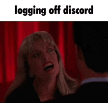 a woman and a man are looking at each other in front of a red curtain and the words `` logging off discord '' .