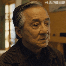 a close up of a man 's face with the hashtag #karatekidmovie on the bottom