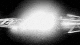 a black and white photo of a light coming out of a building