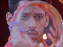 a close up of a man 's face with a rainbow on his forehead