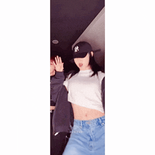 a girl wearing a ny hat and a crop top