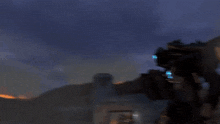 a blurry picture of a robot with a blue light coming out of it 's mouth