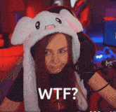 a woman wearing a bunny hat with the word wtf written on it