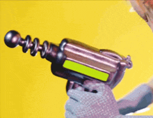 a person is holding a toy gun with a green screen