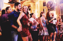 a group of people are dancing in a room with the word zoom visible in the corner