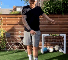 a man in a black shirt is standing in front of a soccer goal that says lasbos