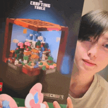 a girl holding a minecraft crafting table