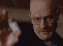 a close up of a man wearing glasses and a black jacket