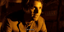 a man in a suit is saying `` i 'm sorry '' .