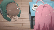 a man and a girl are kneeling down in front of a table with a cup of coffee