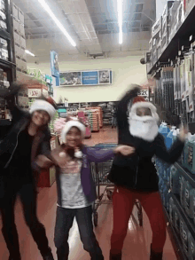 three people in santa hats are dancing in a store with a sign that says $ 20