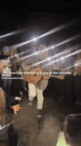 a man playing a guitar in front of a crowd with a caption that says you 'll be married