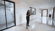 a woman is standing in an empty room with sliding glass doors