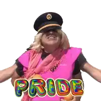 a man wearing a hat and a pink vest is holding an orange and the word pride is above him