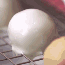a close up of a white ball on a wire rack