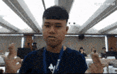a young man in a blue shirt with a lanyard that says pixverse ai