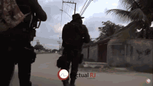 two soldiers are walking down a street with the words actual rj in the corner