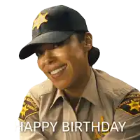 a woman in a sheriff 's uniform is smiling and says " happy birthday "