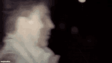 a blurry picture of a man 's face in the dark