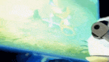 a cartoon character is standing in front of a computer screen looking at a fish tank .