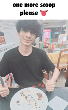 a man sitting at a table with a plate of food and a sign that says " one more scoop please "