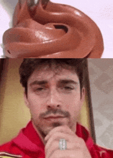 a close up of a chocolate frosting next to a man 's face with a ring on his finger