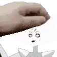 a hand is reaching out towards a cartoon character with a face on it .
