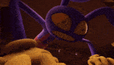 a close up of a purple cartoon character with a yellow face