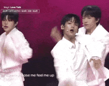 a group of young men are standing next to each other on stage .