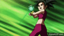 a girl is holding a blue ball in her hand .