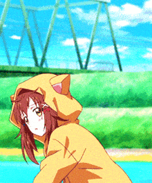 a girl wearing a yellow jacket with a cat ear hood