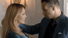 a man and woman are looking into each other 's eyes with a bet logo in the corner of their pocket